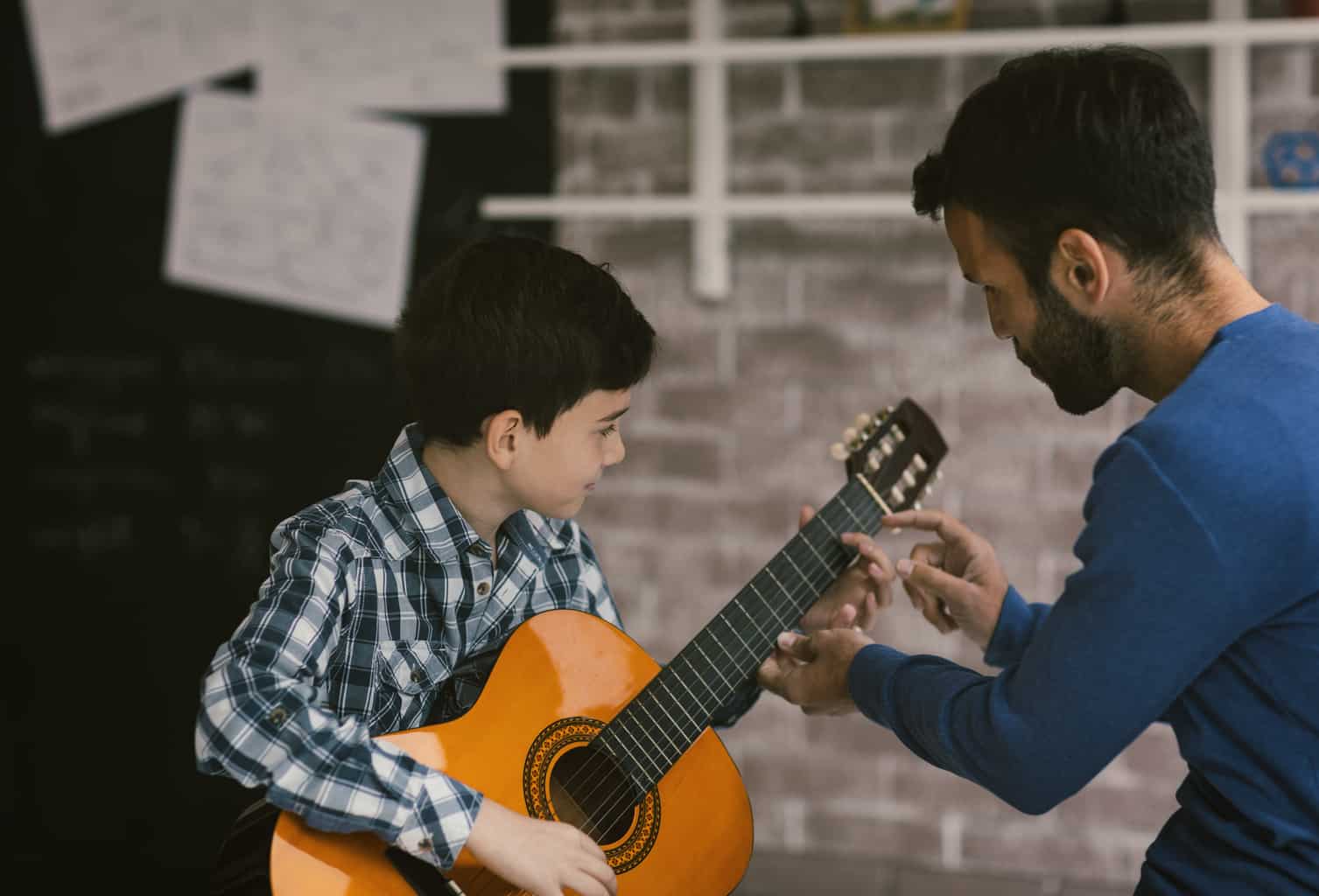 Child receiving a guitar lesson at Maestro Musicians Cleveland