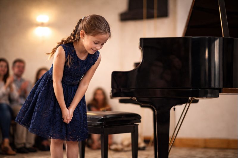 Student bowing after a piano recital